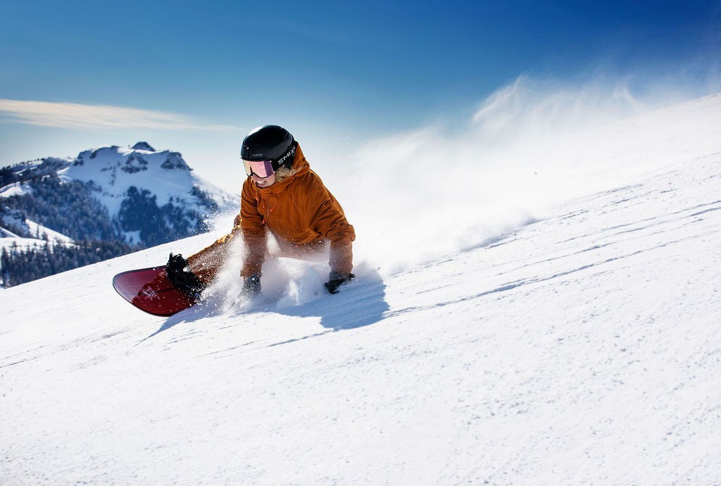 Female snowboarder making a turn